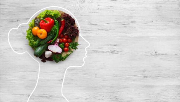 outline of a woman's profile with vegetables in the space inside her brain