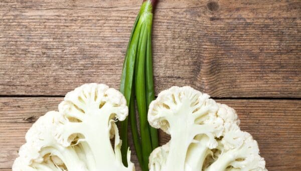 cauliflower split into half with green onions imitating lungs and windpipe