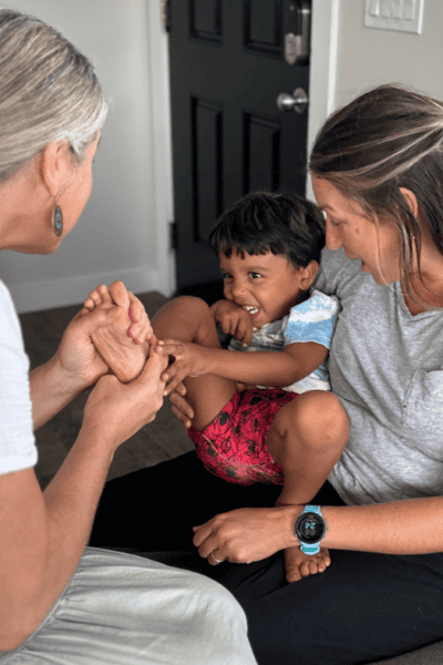 amber bodily foot zoning a small child who is being held on the lap of his mother