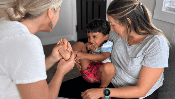 amber bodily foot zoning a small child who is being held on the lap of his mother